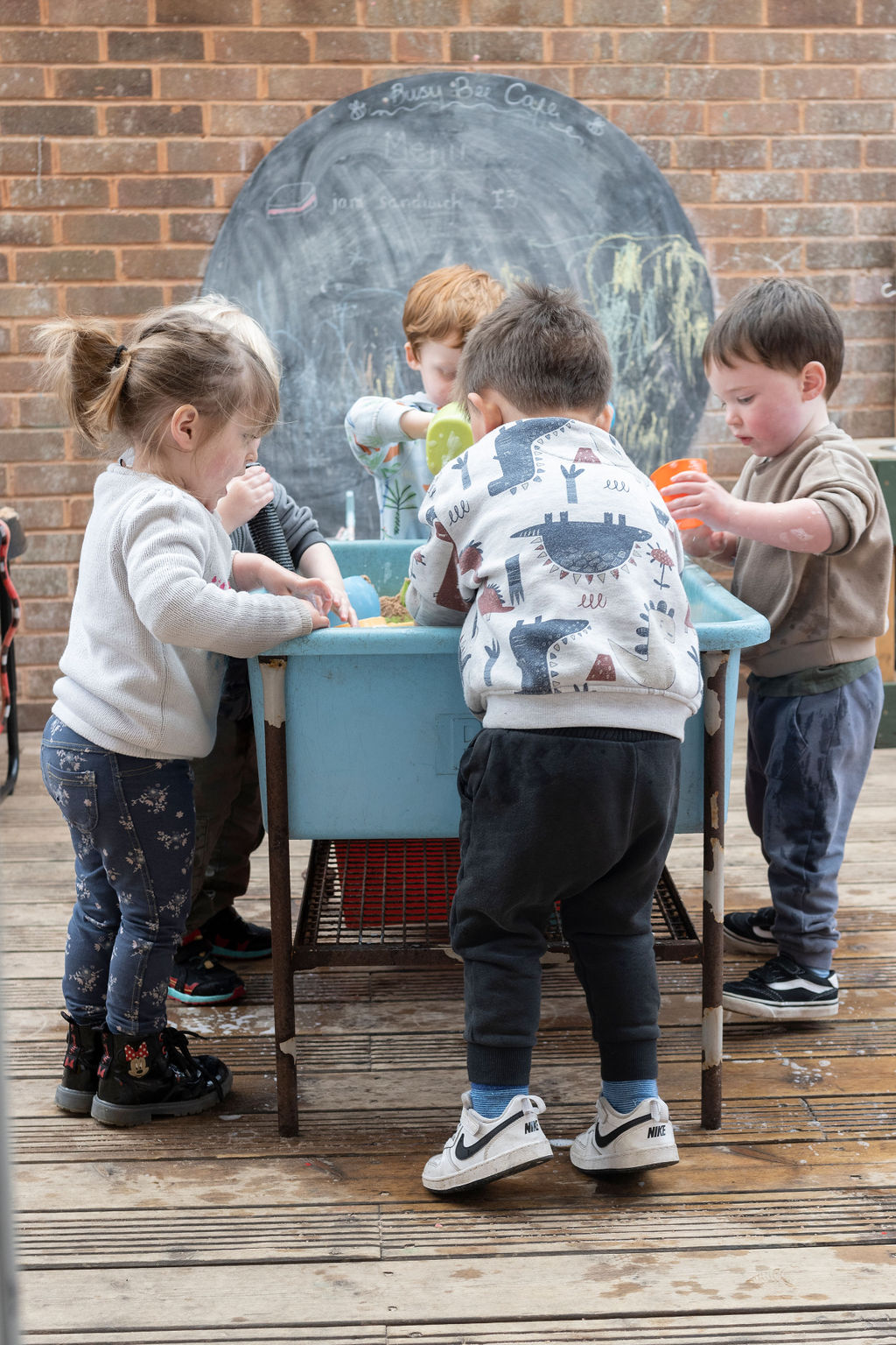Children exploring with a nursery team member